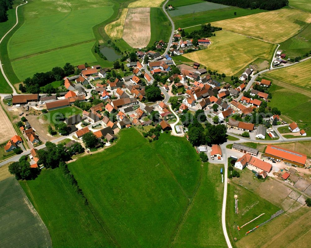 Sachsbach from above - Agricultural land and field boundaries surround the settlement area of the village in Sachsbach in the state Bavaria, Germany