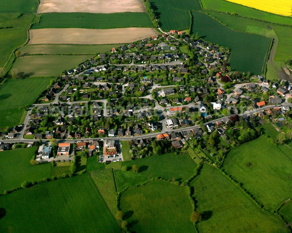 Aerial image Sandesneben - Agricultural land and field boundaries surround the settlement area of the village in Sandesneben in the state Schleswig-Holstein, Germany