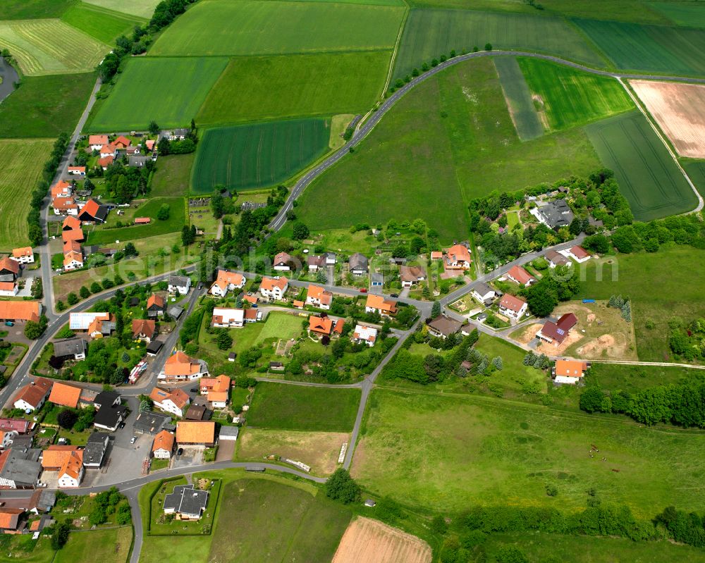 Aerial image Sandlofs - Agricultural land and field boundaries surround the settlement area of the village in Sandlofs in the state Hesse, Germany