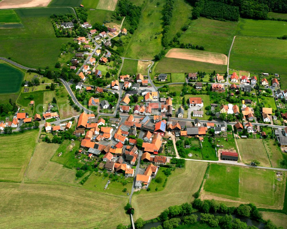 Aerial photograph Sandlofs - Agricultural land and field boundaries surround the settlement area of the village in Sandlofs in the state Hesse, Germany