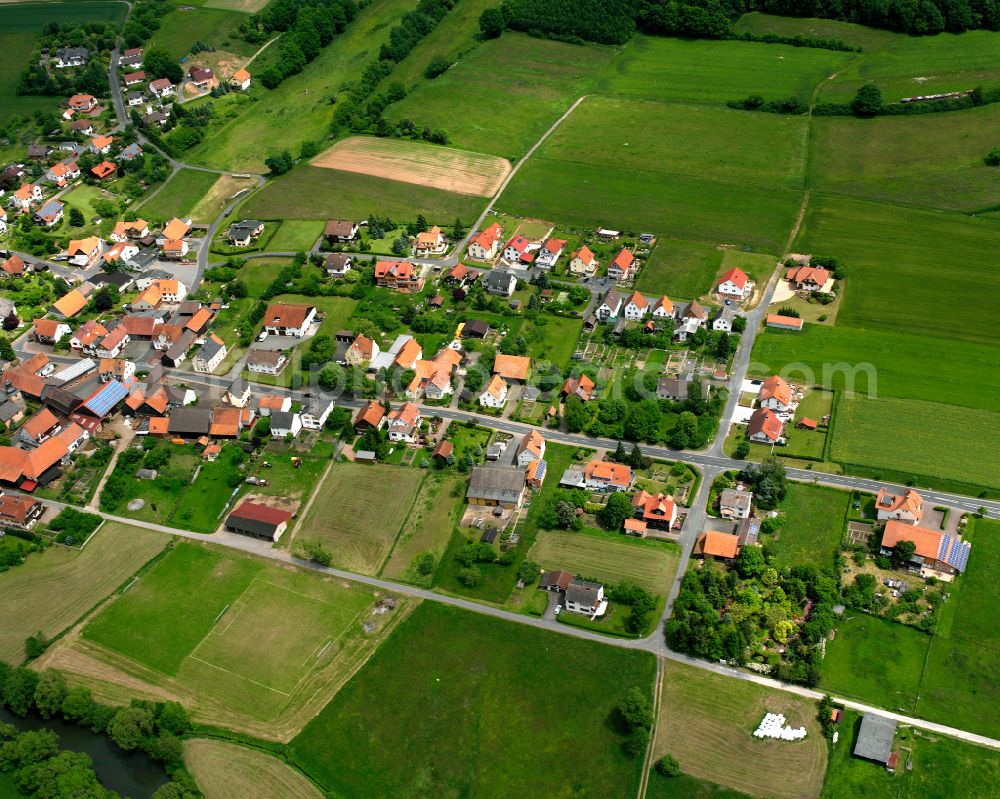 Sandlofs from above - Agricultural land and field boundaries surround the settlement area of the village in Sandlofs in the state Hesse, Germany