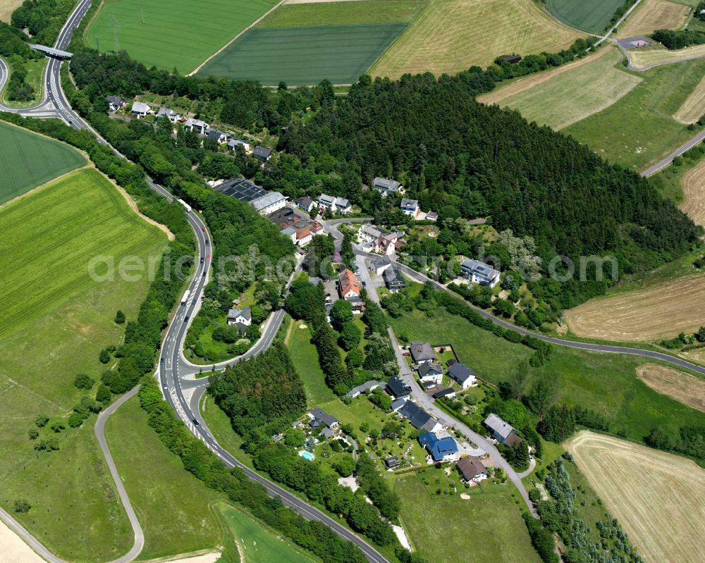 Aerial photograph Sauerbrunnen - Agricultural land and field boundaries surround the settlement area of the village in Sauerbrunnen in the state Rhineland-Palatinate, Germany