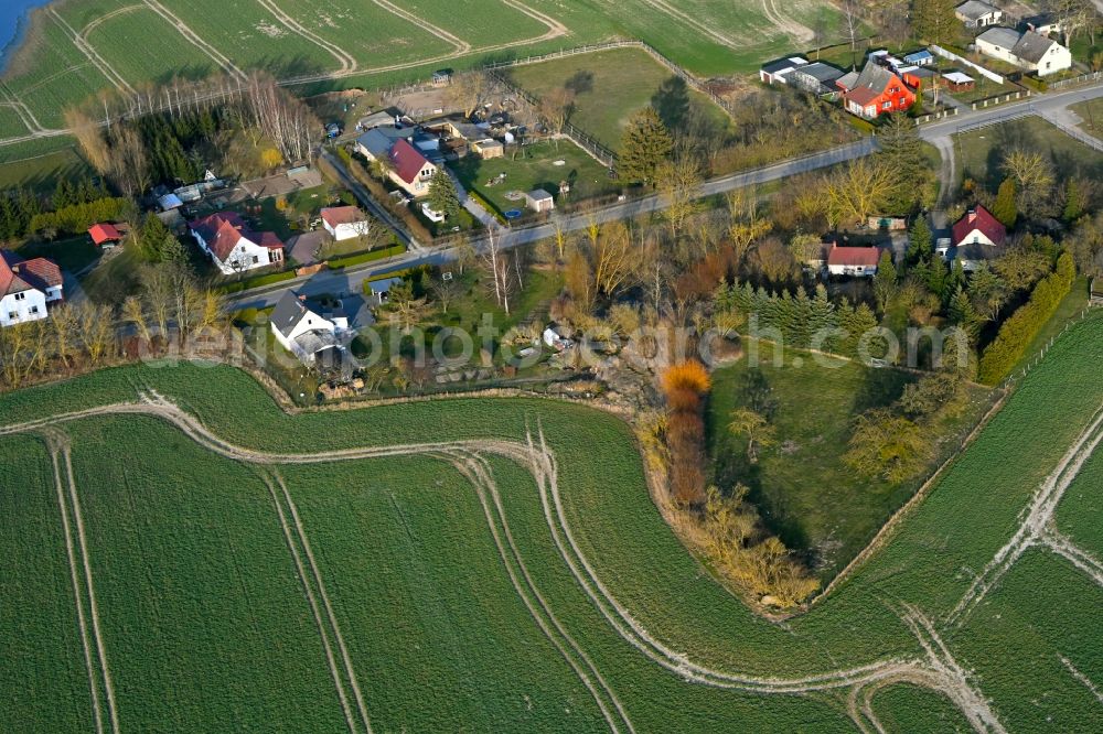 Schapow from the bird's eye view: Agricultural land and field boundaries surround the settlement area of the village in Schapow Uckermark in the state Brandenburg, Germany