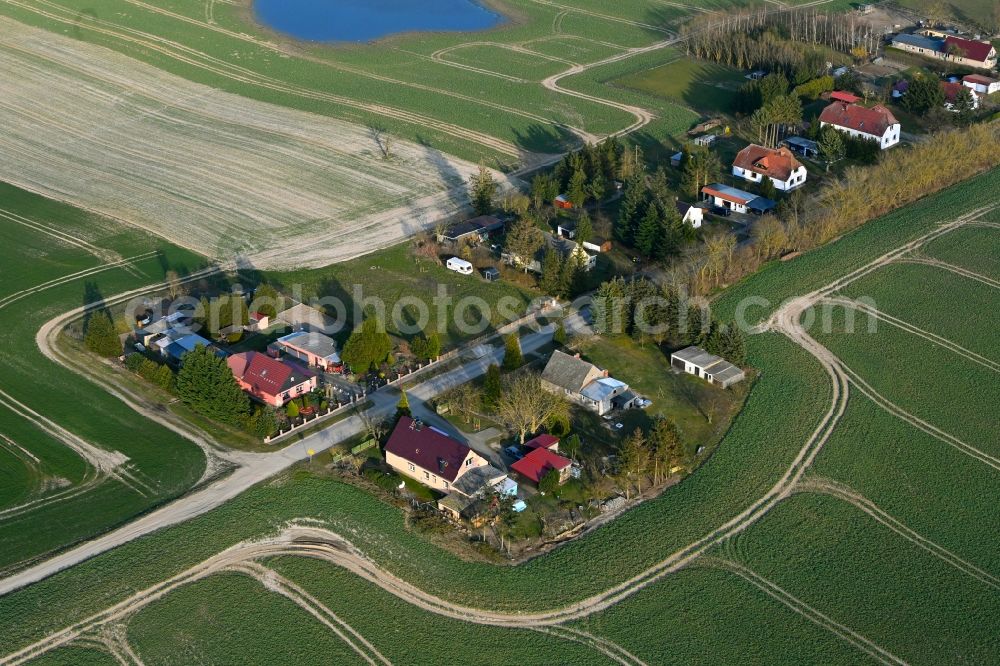 Schapow from above - Agricultural land and field boundaries surround the settlement area of the village in Schapow Uckermark in the state Brandenburg, Germany