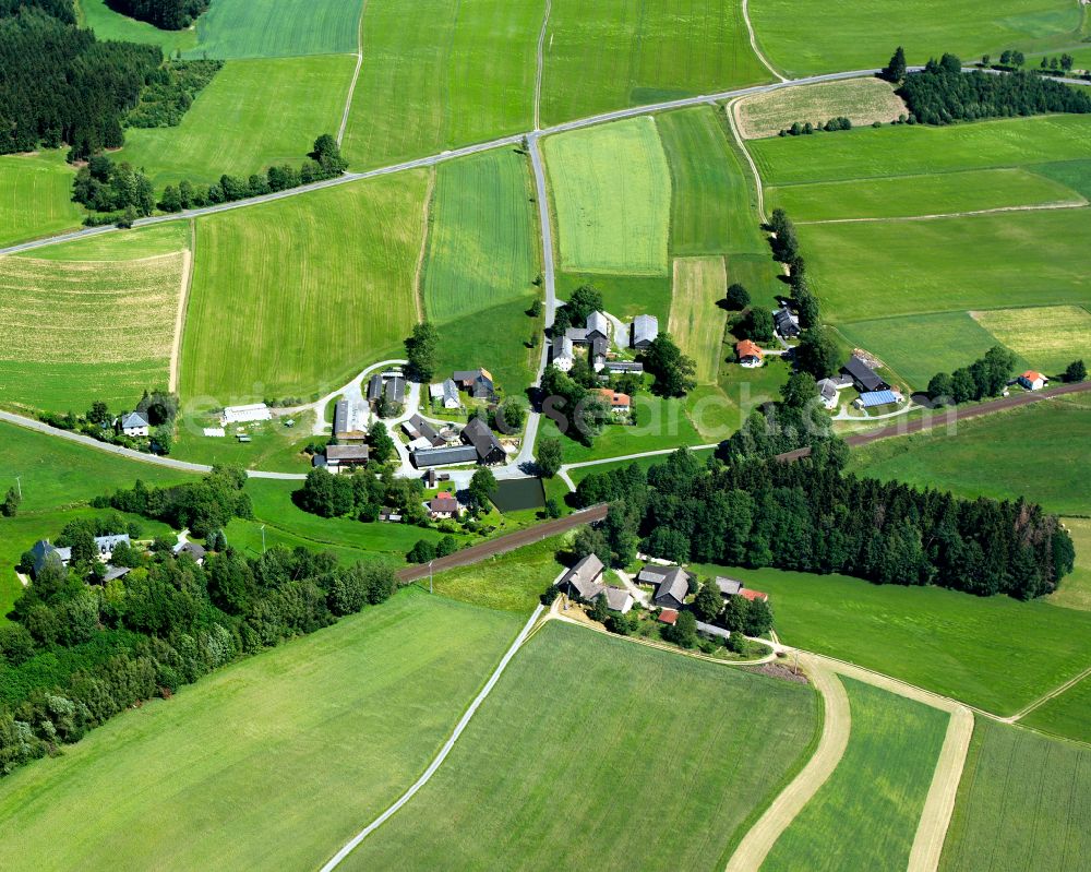 Aerial image Schödlas - Agricultural land and field boundaries surround the settlement area of the village in Schödlas in the state Bavaria, Germany