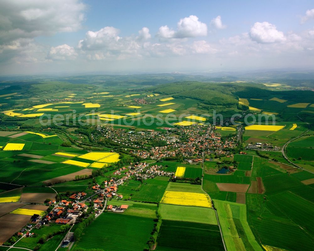 Aerial image Schenklengsfeld - Agricultural land and field boundaries surround the settlement area of the village in Schenklengsfeld in the state Hesse, Germany