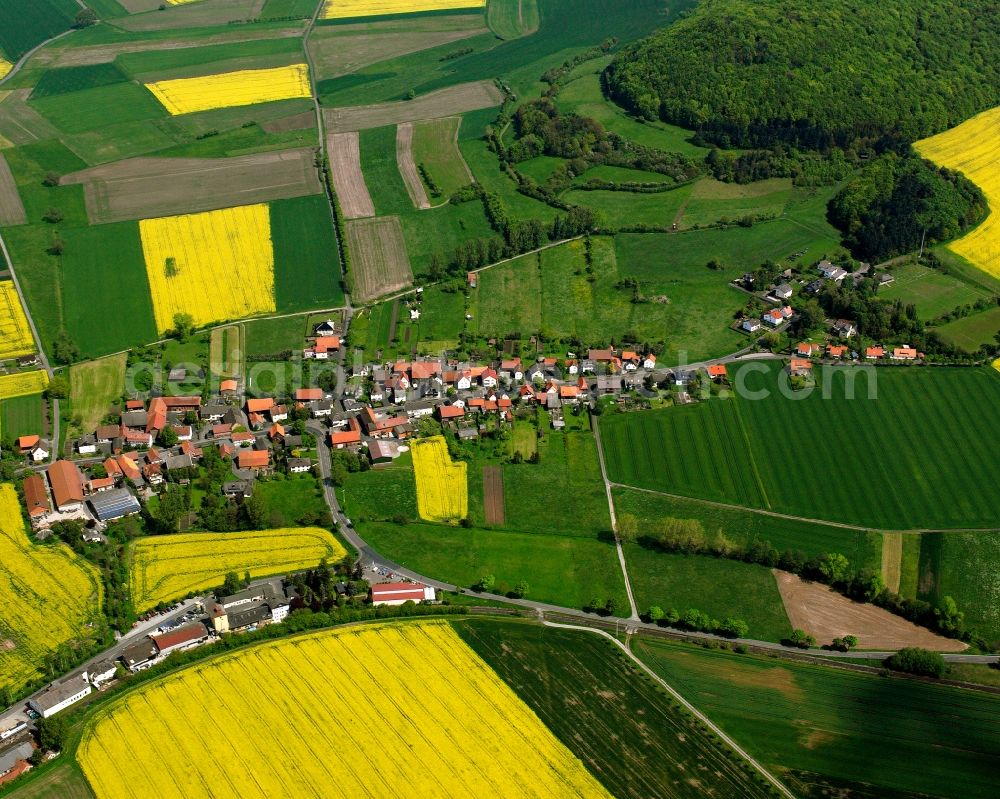 Aerial photograph Schenklengsfeld - Agricultural land and field boundaries surround the settlement area of the village in Schenklengsfeld in the state Hesse, Germany