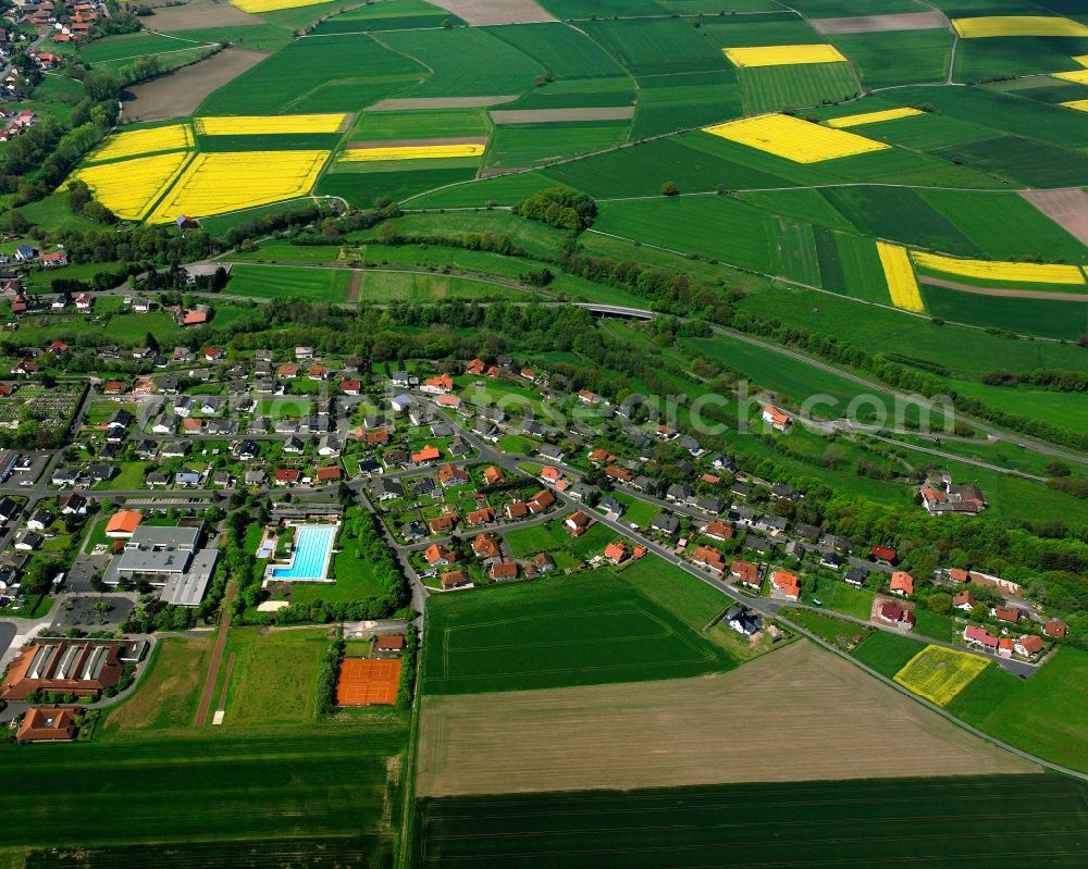 Aerial image Schenklengsfeld - Agricultural land and field boundaries surround the settlement area of the village in Schenklengsfeld in the state Hesse, Germany