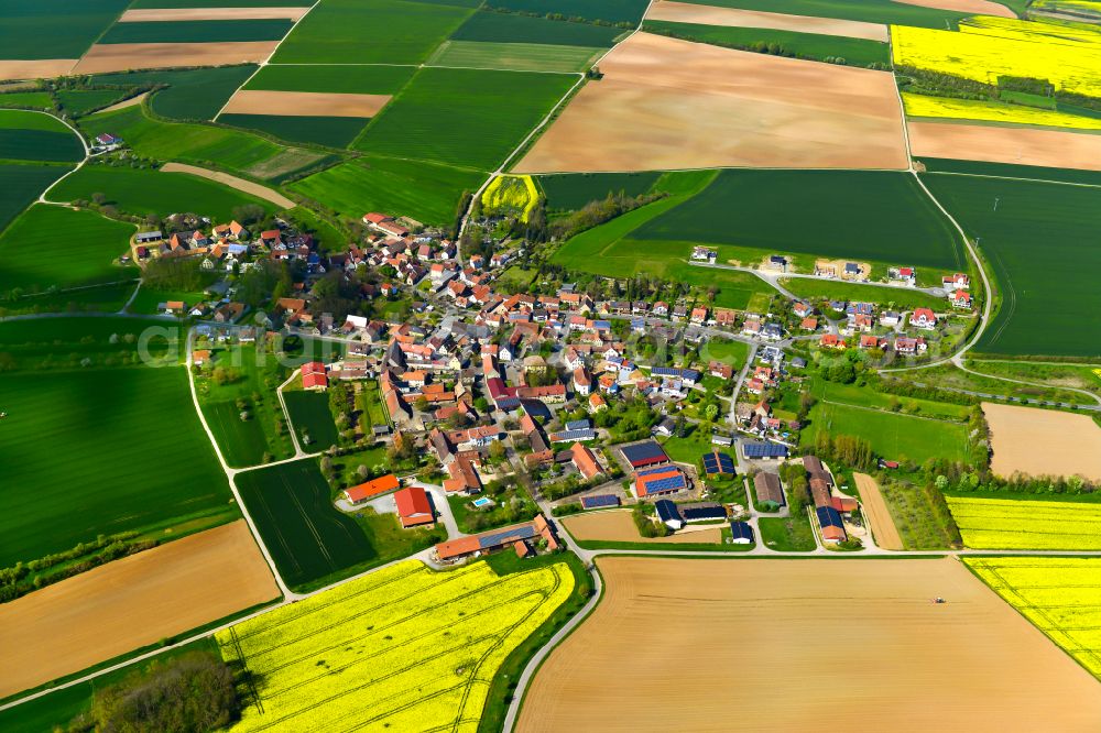 Aerial image Schernau - Agricultural land and field boundaries surround the settlement area of the village in Schernau in the state Bavaria, Germany