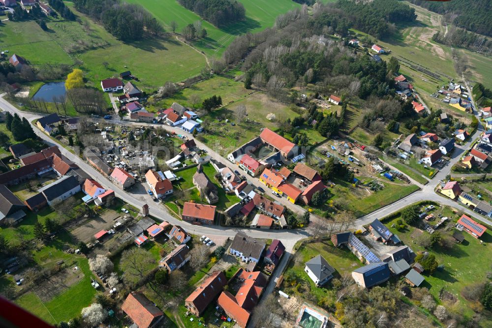 Aerial photograph Schlamau - Agricultural land and field boundaries surround the settlement area of the village in Schlamau in the state Brandenburg, Germany