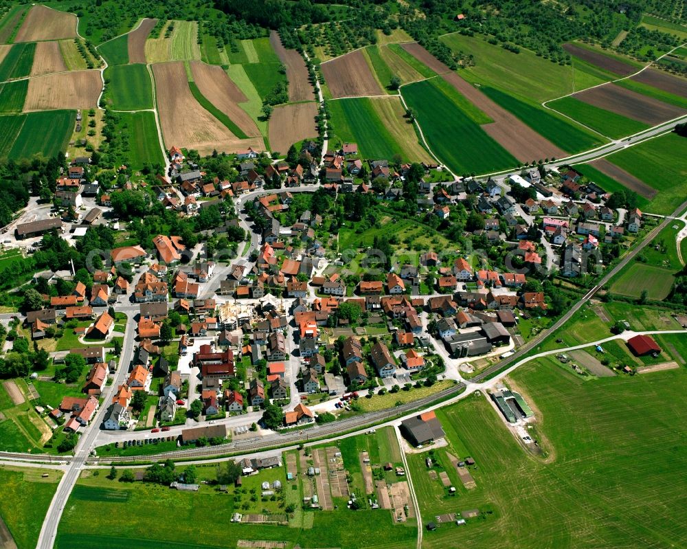 Schlechtbach from above - Agricultural land and field boundaries surround the settlement area of the village in Schlechtbach in the state Baden-Wuerttemberg, Germany