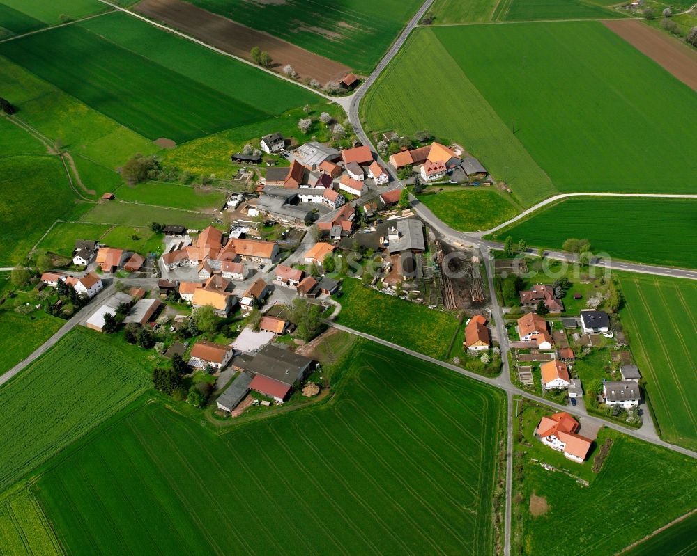 Aerial photograph Schletzenrod - Agricultural land and field boundaries surround the settlement area of the village in Schletzenrod in the state Hesse, Germany