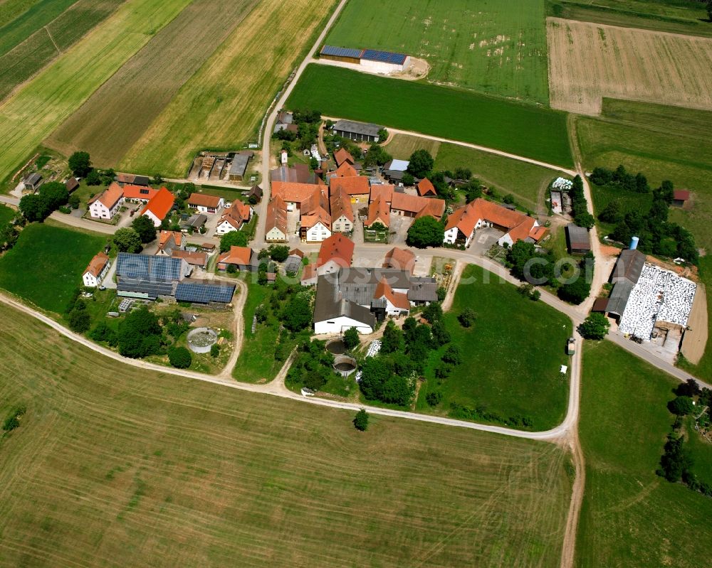 Schlierberg from above - Agricultural land and field boundaries surround the settlement area of the village in Schlierberg in the state Bavaria, Germany