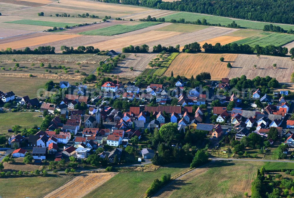 Schlimpfhof from above - Agricultural land and field boundaries surround the settlement area of the village in Schlimpfhof in the state Bavaria, Germany