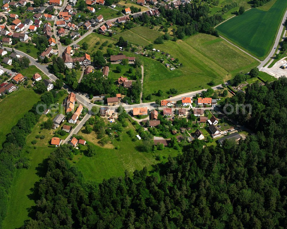 Schömberg from the bird's eye view: Agricultural land and field boundaries surround the settlement area of the village in Schömberg in the state Baden-Wuerttemberg, Germany