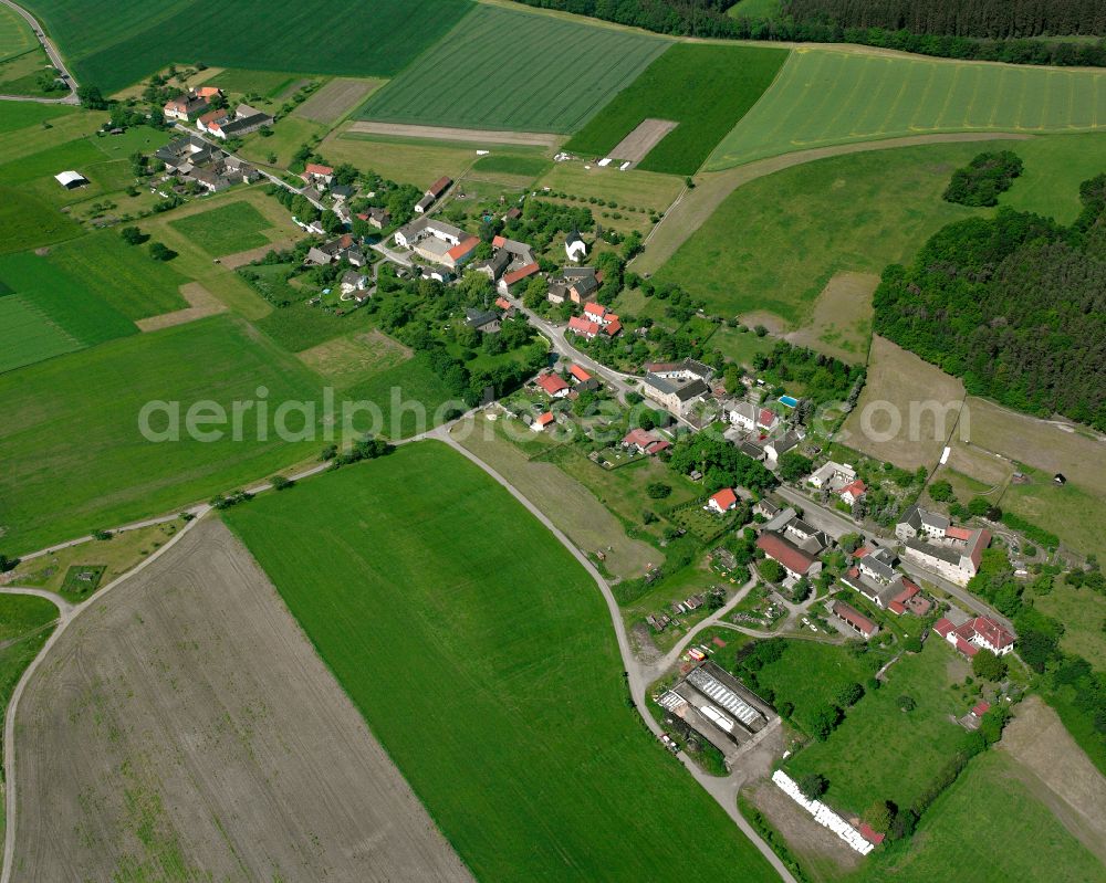 Aerial image Schömberg - Agricultural land and field boundaries surround the settlement area of the village in Schömberg in the state Thuringia, Germany