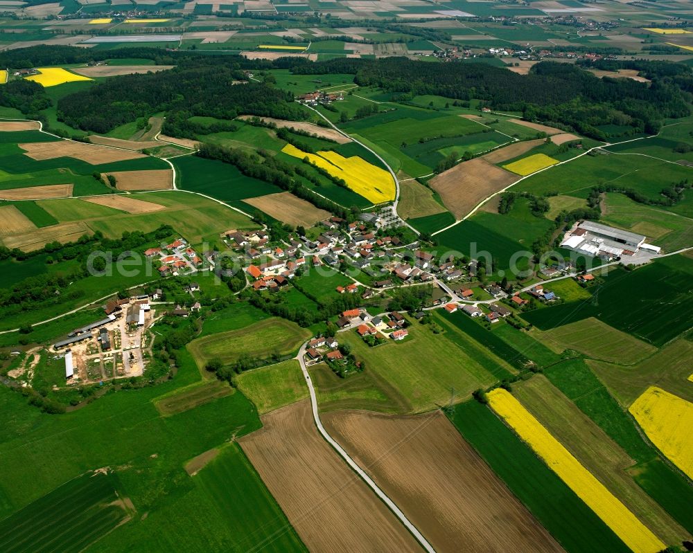 Schmiedorf from above - Agricultural land and field boundaries surround the settlement area of the village in Schmiedorf in the state Bavaria, Germany