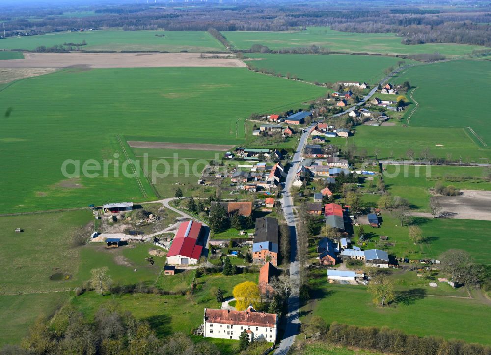 Schmolde from the bird's eye view: Agricultural land and field boundaries surround the settlement area of the village in Schmolde in the state Brandenburg, Germany