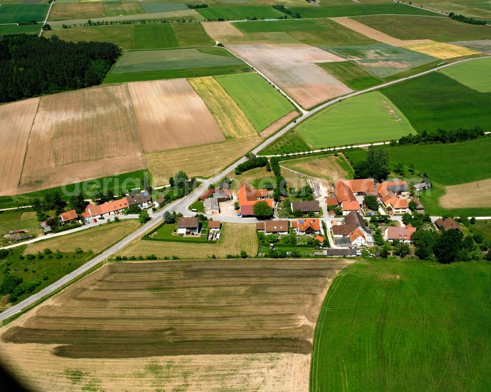 Schönau from the bird's eye view: Agricultural land and field boundaries surround the settlement area of the village in Schönau in the state Bavaria, Germany