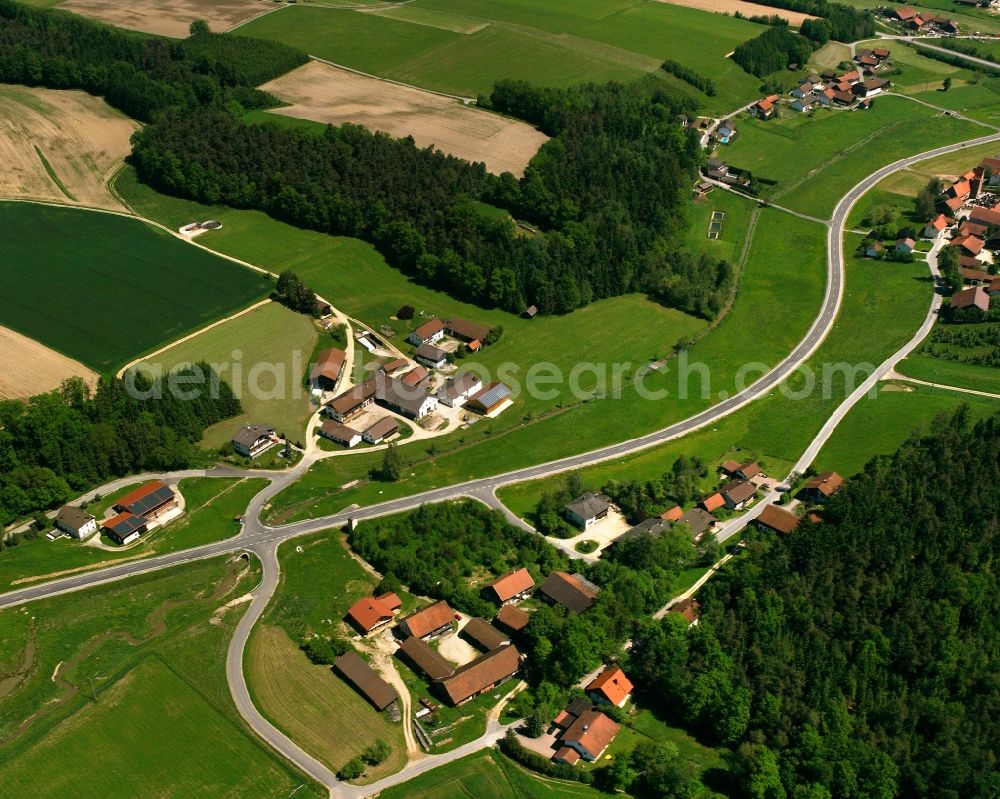 Schönau from the bird's eye view: Agricultural land and field boundaries surround the settlement area of the village in Schönau in the state Bavaria, Germany