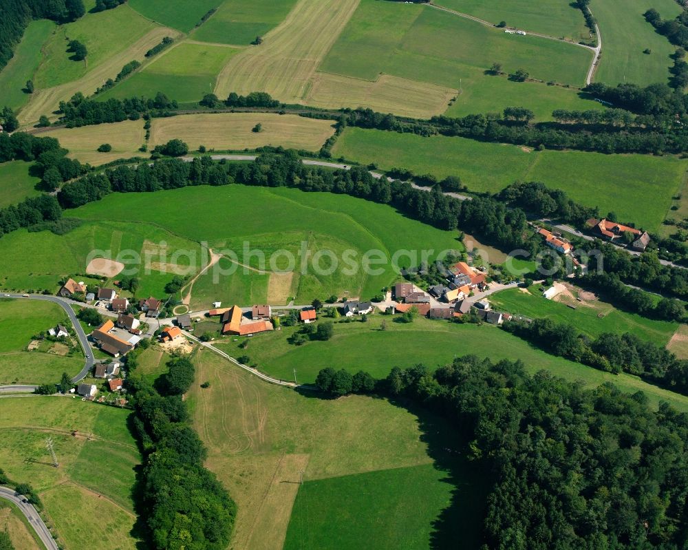 Schönnen from above - Agricultural land and field boundaries surround the settlement area of the village in Schönnen in the state Hesse, Germany