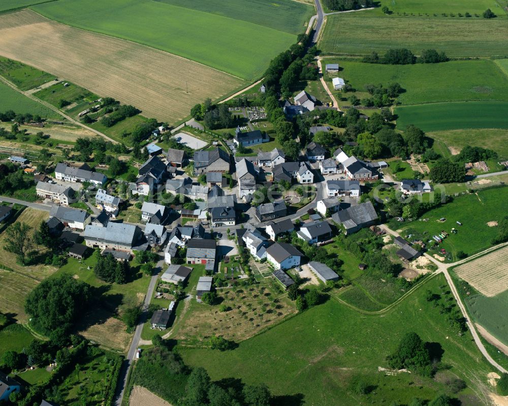 Aerial image Schnorbach - Agricultural land and field boundaries surround the settlement area of the village in Schnorbach in the state Rhineland-Palatinate, Germany