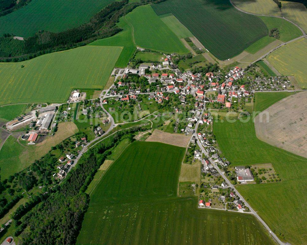 Schüptitz from above - Agricultural land and field boundaries surround the settlement area of the village in Schüptitz in the state Thuringia, Germany