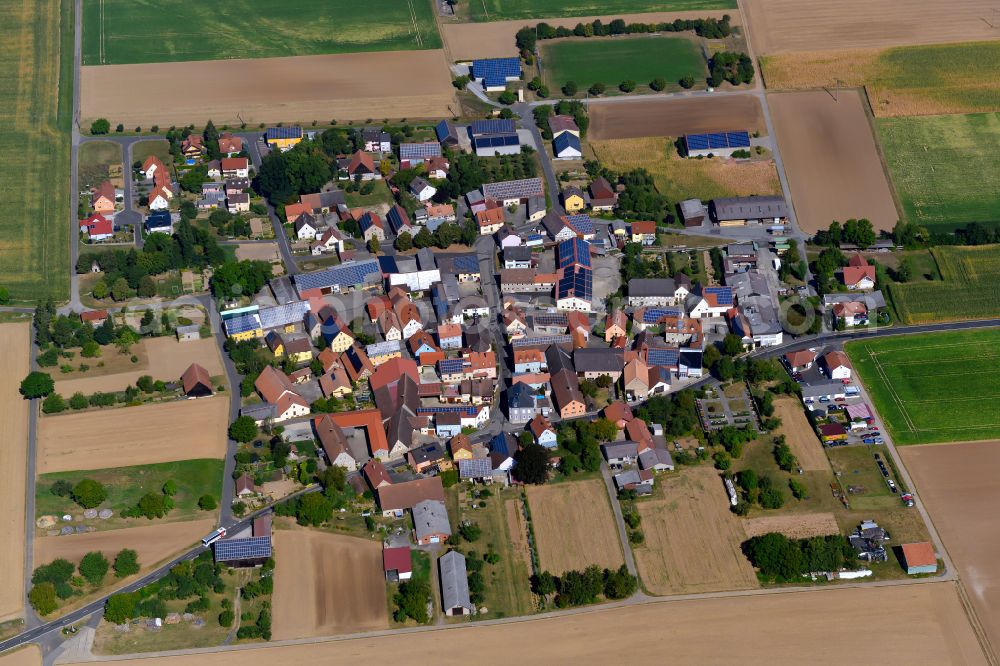 Aerial image Sächsenheim - Agricultural land and field boundaries surround the settlement area of the village in Sächsenheim in the state Bavaria, Germany