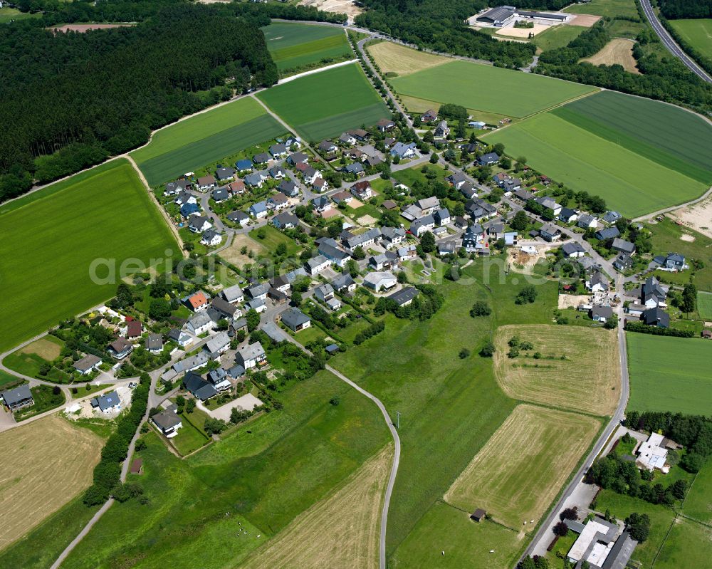 Schwall from above - Agricultural land and field boundaries surround the settlement area of the village in Schwall in the state Rhineland-Palatinate, Germany