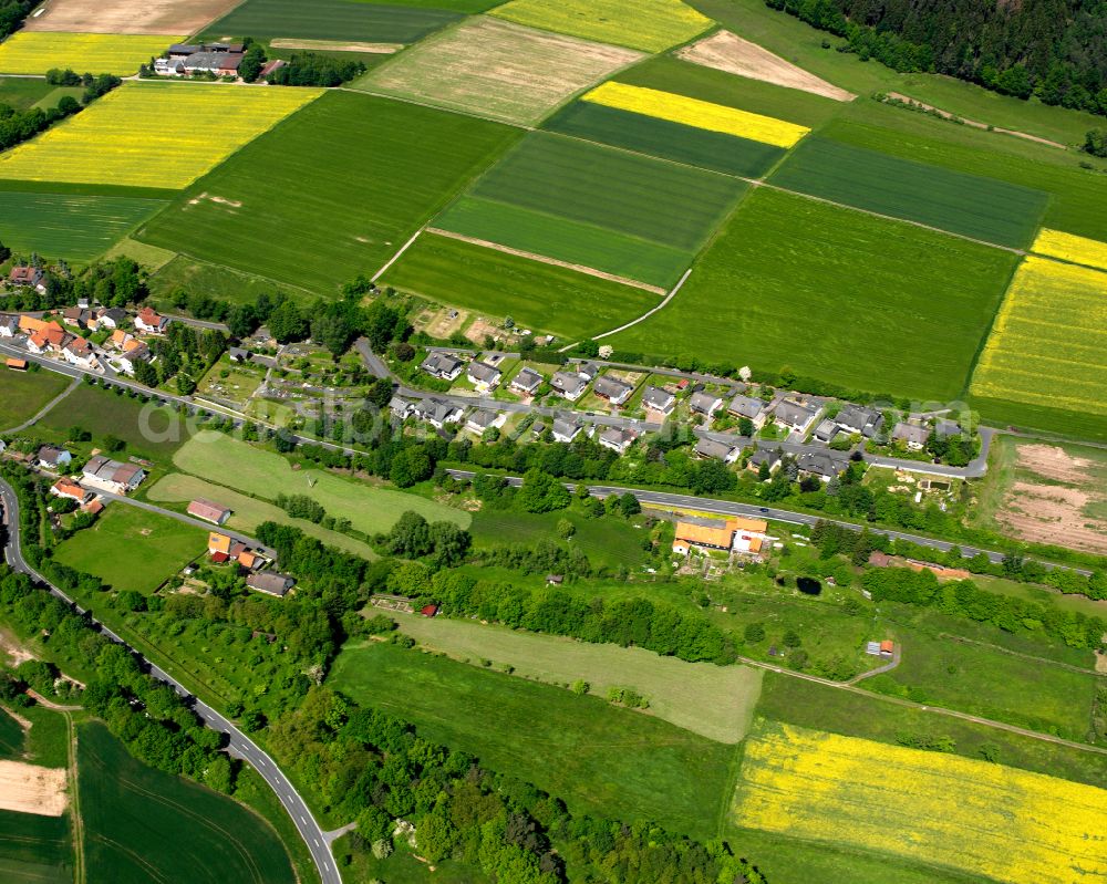 Aerial image Schwarz - Agricultural land and field boundaries surround the settlement area of the village in Schwarz in the state Hesse, Germany