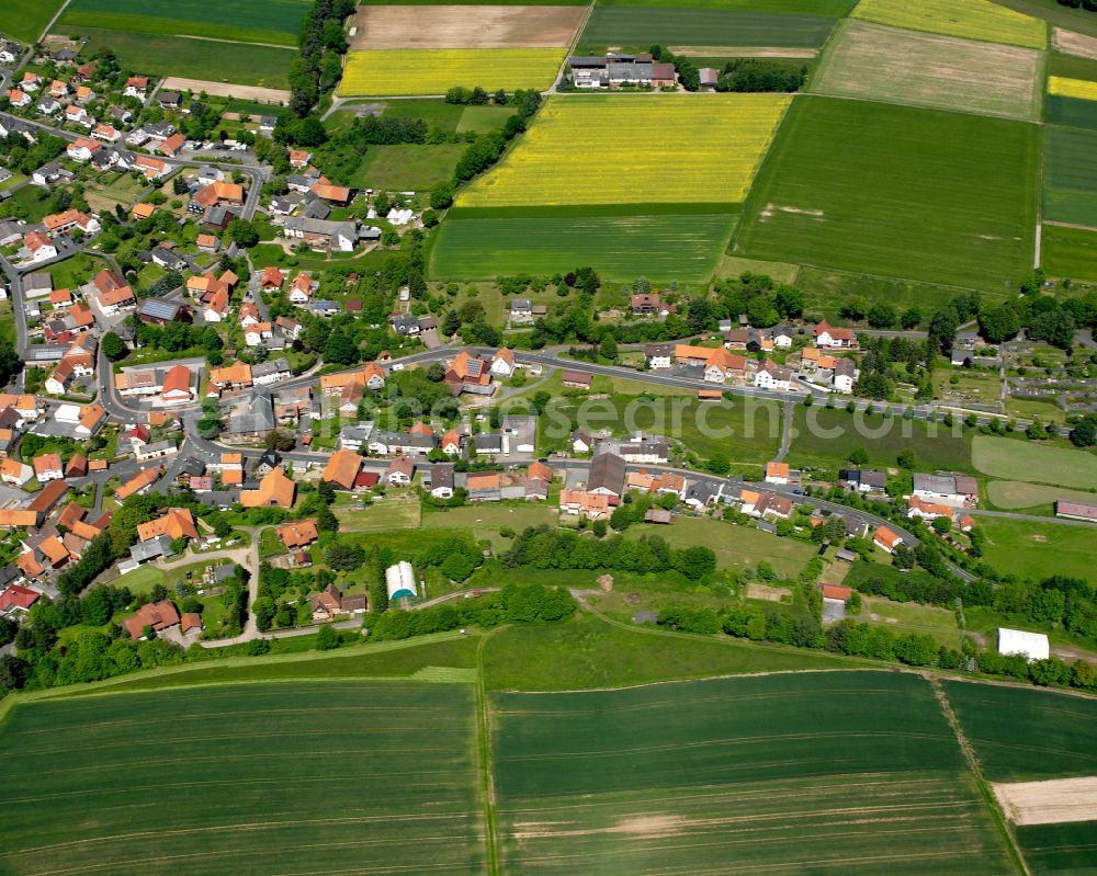 Aerial photograph Schwarz - Agricultural land and field boundaries surround the settlement area of the village in Schwarz in the state Hesse, Germany