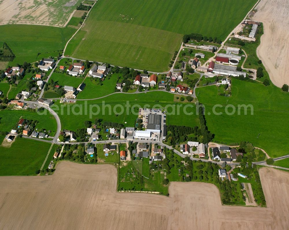 Schwarzbach from above - Agricultural land and field boundaries surround the settlement area of the village in Schwarzbach in the state Saxony, Germany