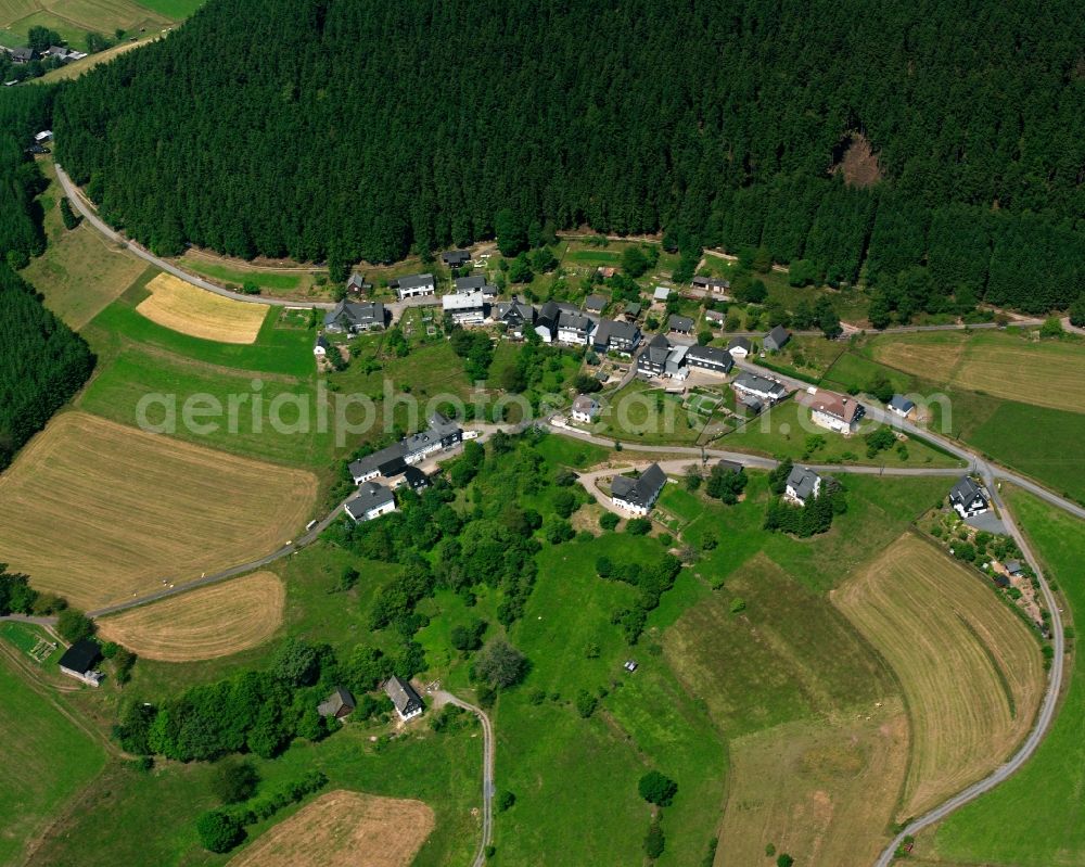 Aerial image Schwarzenau - Agricultural land and field boundaries surround the settlement area of the village in Schwarzenau in the state North Rhine-Westphalia, Germany