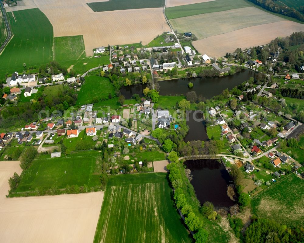 Schweikershain from above - Agricultural land and field boundaries surround the settlement area of the village in Schweikershain in the state Saxony, Germany