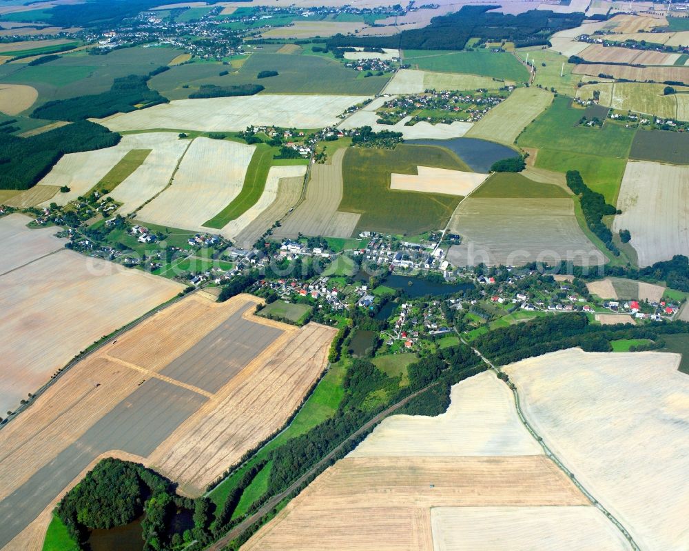 Schweikershain from the bird's eye view: Agricultural land and field boundaries surround the settlement area of the village in Schweikershain in the state Saxony, Germany