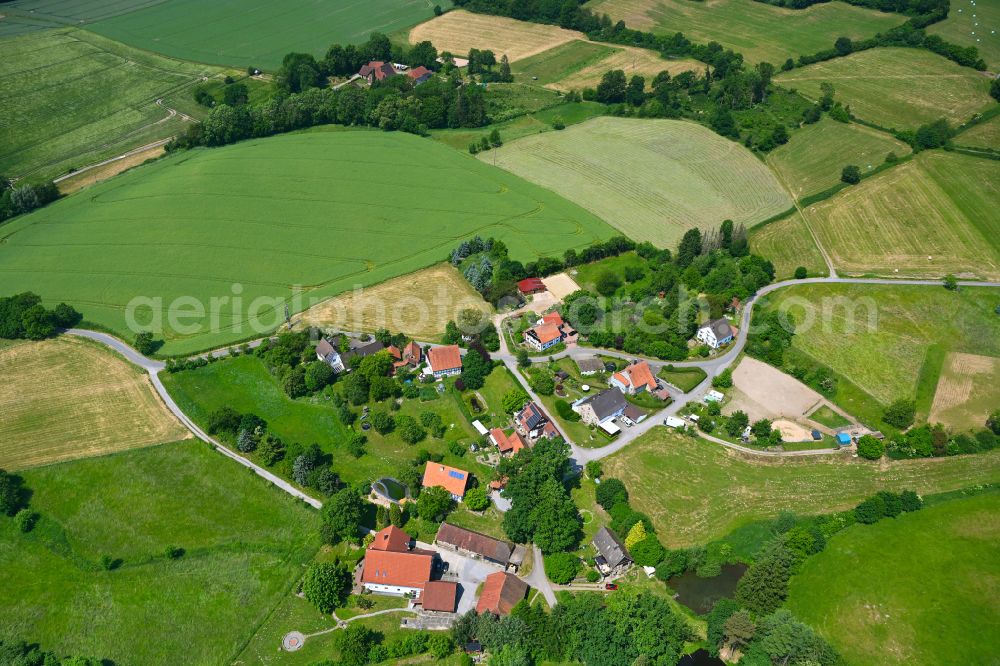 Aerial image Schwelentrup - Agricultural land and field boundaries surround the settlement area of the village in Schwelentrup in the state North Rhine-Westphalia, Germany