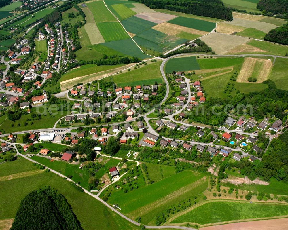 Schwerzen from the bird's eye view: Agricultural land and field boundaries surround the settlement area of the village in Schwerzen in the state Baden-Wuerttemberg, Germany