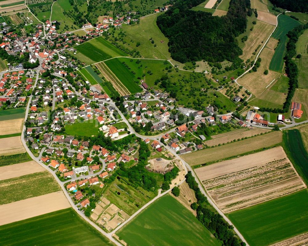 Schwerzen from the bird's eye view: Agricultural land and field boundaries surround the settlement area of the village in Schwerzen in the state Baden-Wuerttemberg, Germany