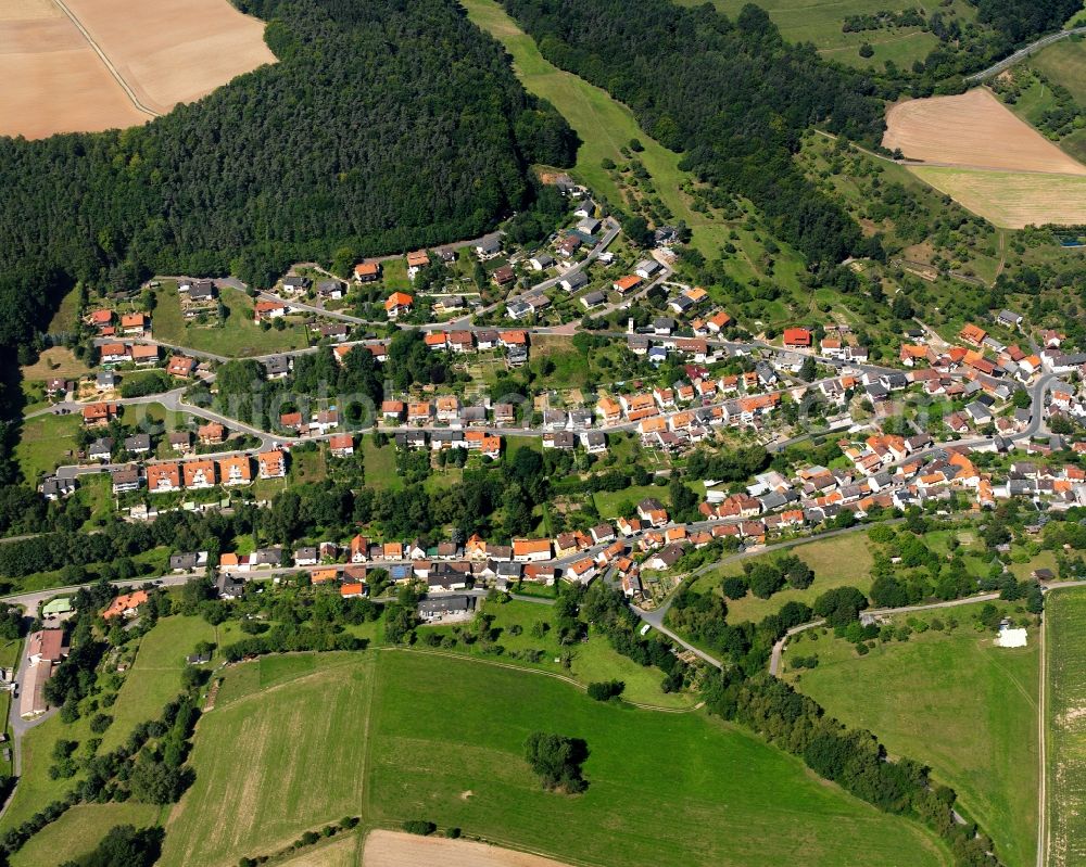 Seckmauern from the bird's eye view: Agricultural land and field boundaries surround the settlement area of the village in Seckmauern in the state Hesse, Germany