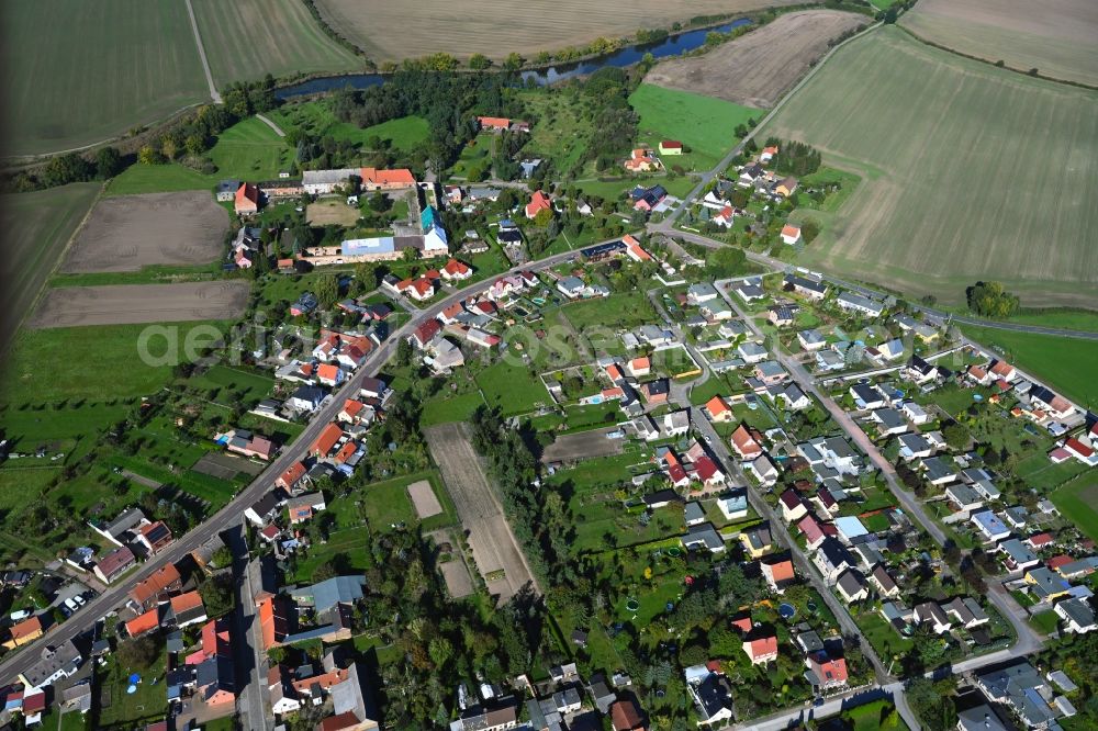 Seegrehna from above - Agricultural land and field boundaries surround the settlement area of the village in Seegrehna in the state Saxony-Anhalt, Germany