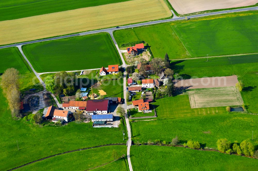 Seeramsmühle from the bird's eye view: Agricultural land and field boundaries surround the settlement area of the village in Seeramsmühle in the state Bavaria, Germany