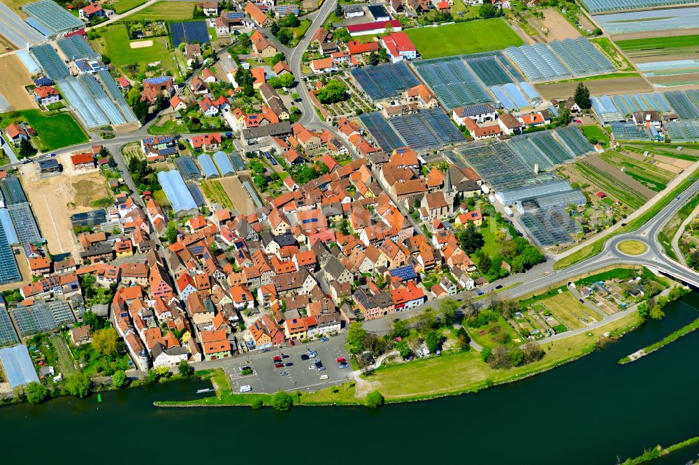 Segnitz from above - Agricultural land and field boundaries surround the settlement area of the village in Segnitz in the state Bavaria, Germany