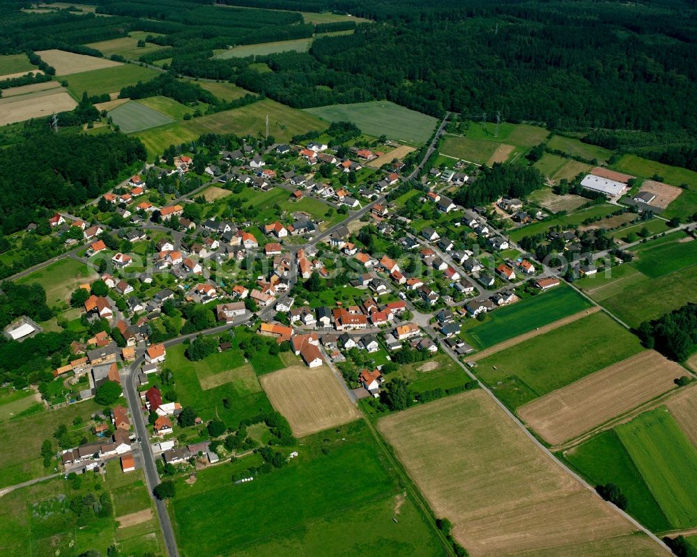 Aerial image Sichelnstein - Agricultural land and field boundaries surround the settlement area of the village in Sichelnstein in the state Lower Saxony, Germany