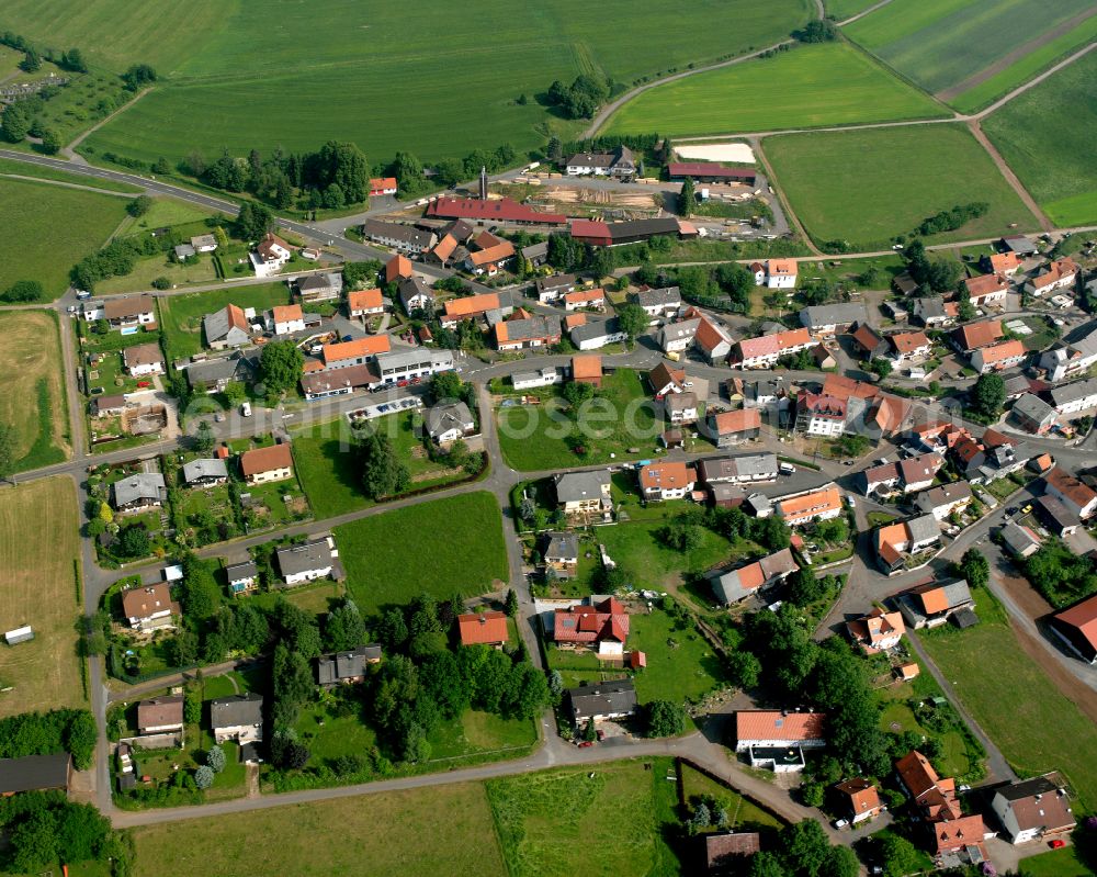 Aerial image Sichenhausen - Agricultural land and field boundaries surround the settlement area of the village in Sichenhausen in the state Hesse, Germany