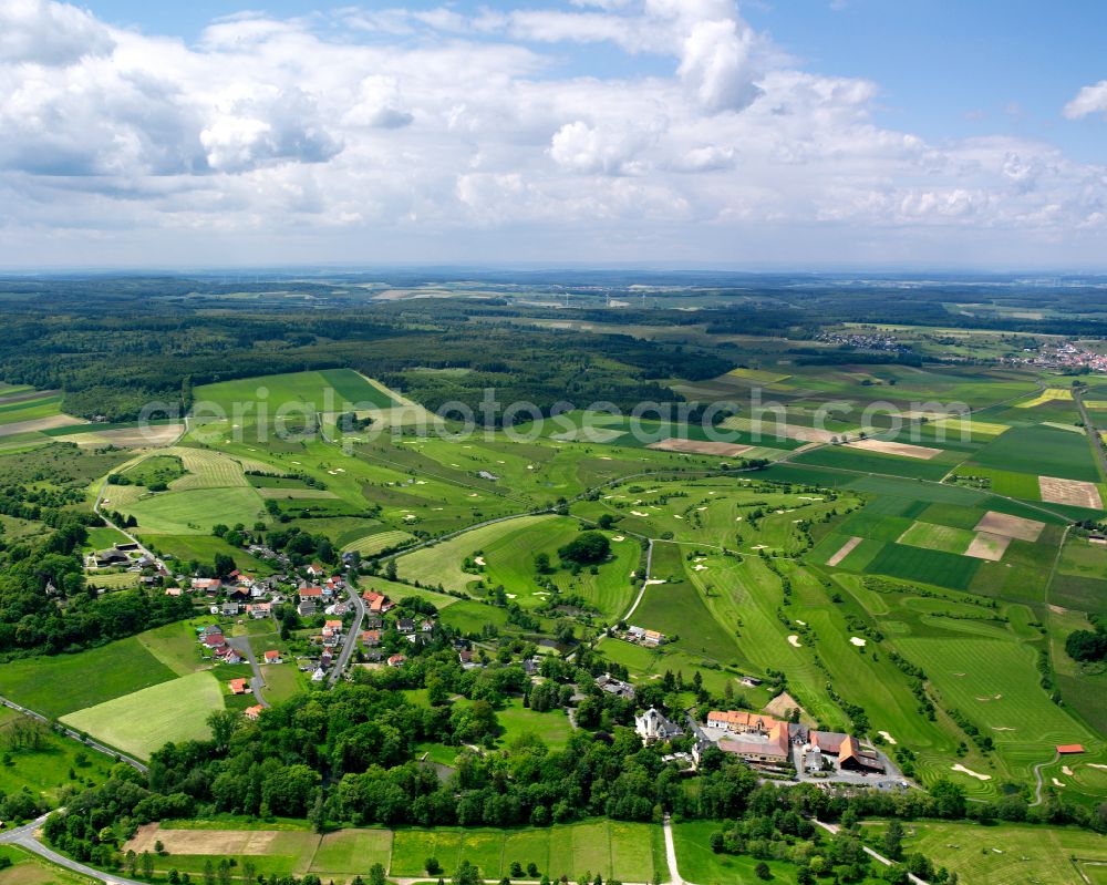 Sickendorf from the bird's eye view: Agricultural land and field boundaries surround the settlement area of the village in Sickendorf in the state Hesse, Germany