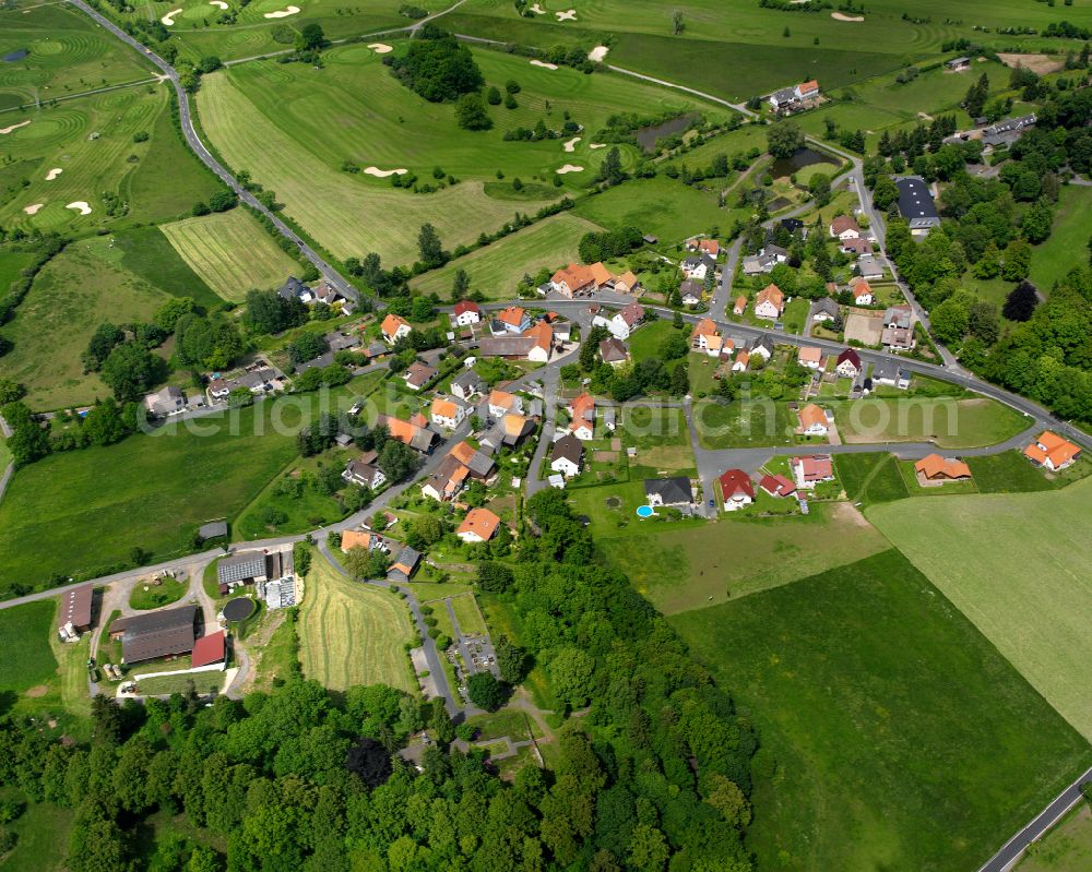 Aerial image Sickendorf - Agricultural land and field boundaries surround the settlement area of the village in Sickendorf in the state Hesse, Germany