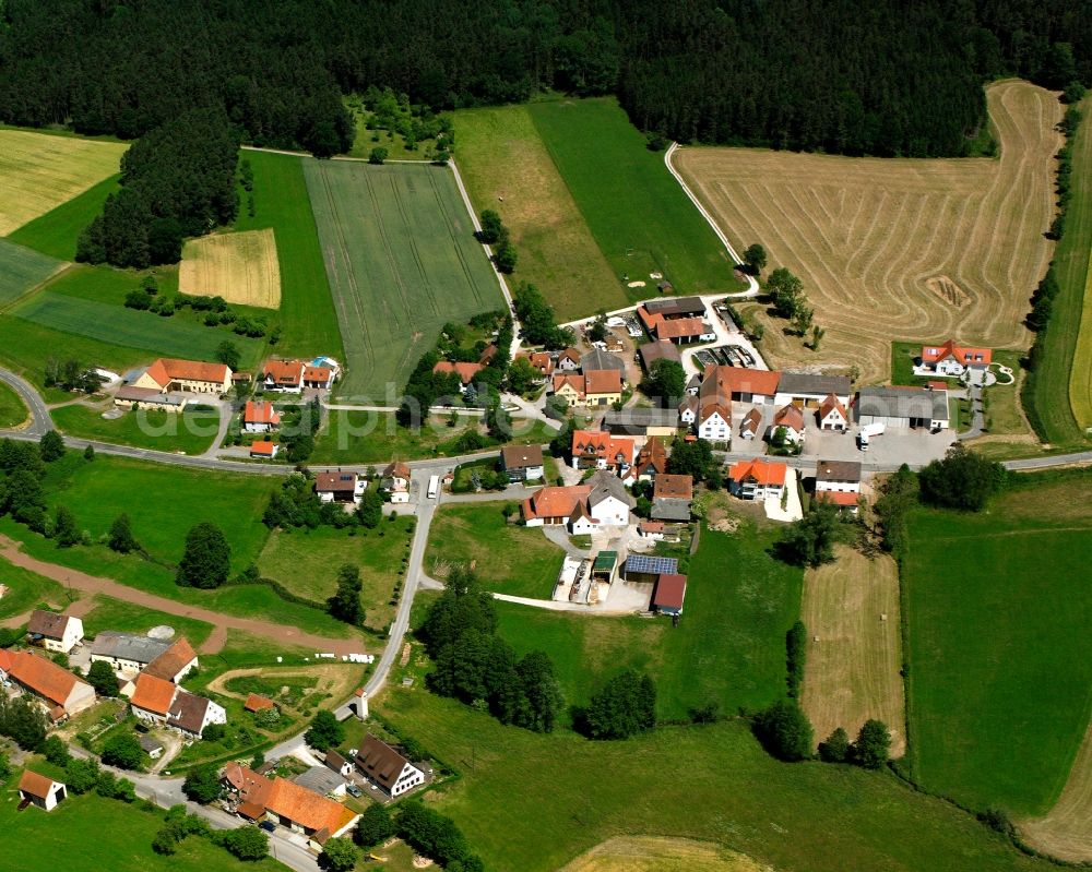 Sickersdorf from the bird's eye view: Agricultural land and field boundaries surround the settlement area of the village in Sickersdorf in the state Bavaria, Germany