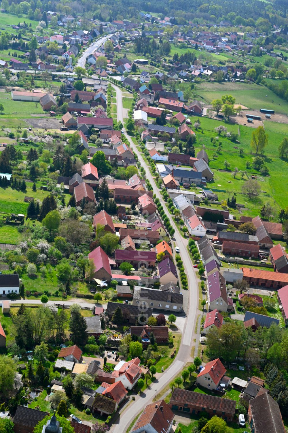 Sieversdorf from the bird's eye view: Agricultural land and field boundaries surround the settlement area of the village in Sieversdorf in the state Brandenburg, Germany