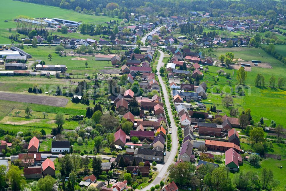 Aerial photograph Sieversdorf - Agricultural land and field boundaries surround the settlement area of the village in Sieversdorf in the state Brandenburg, Germany