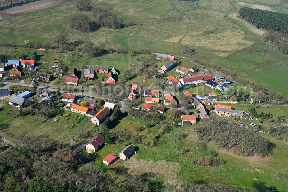 Siggelkow from the bird's eye view: Agricultural land and field boundaries surround the settlement area of the village in Siggelkow in the state Mecklenburg - Western Pomerania, Germany